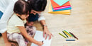A mother and daughter do an art activity at home together.